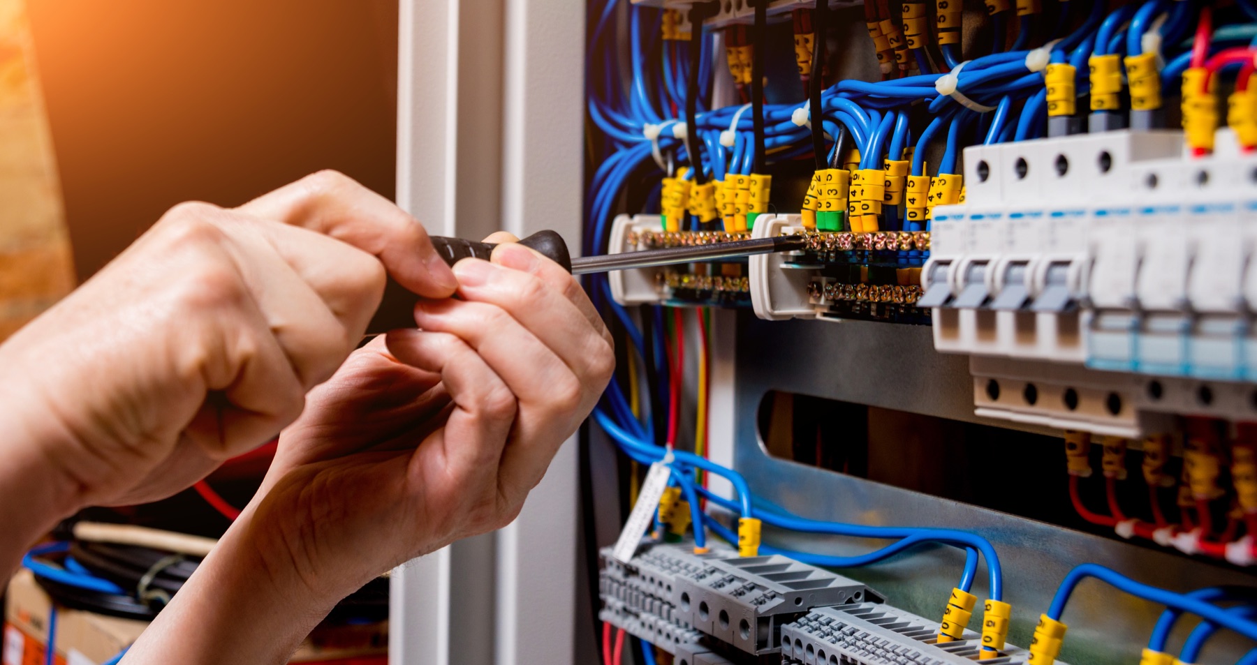 Electrical technician terminating a distribution switchboard